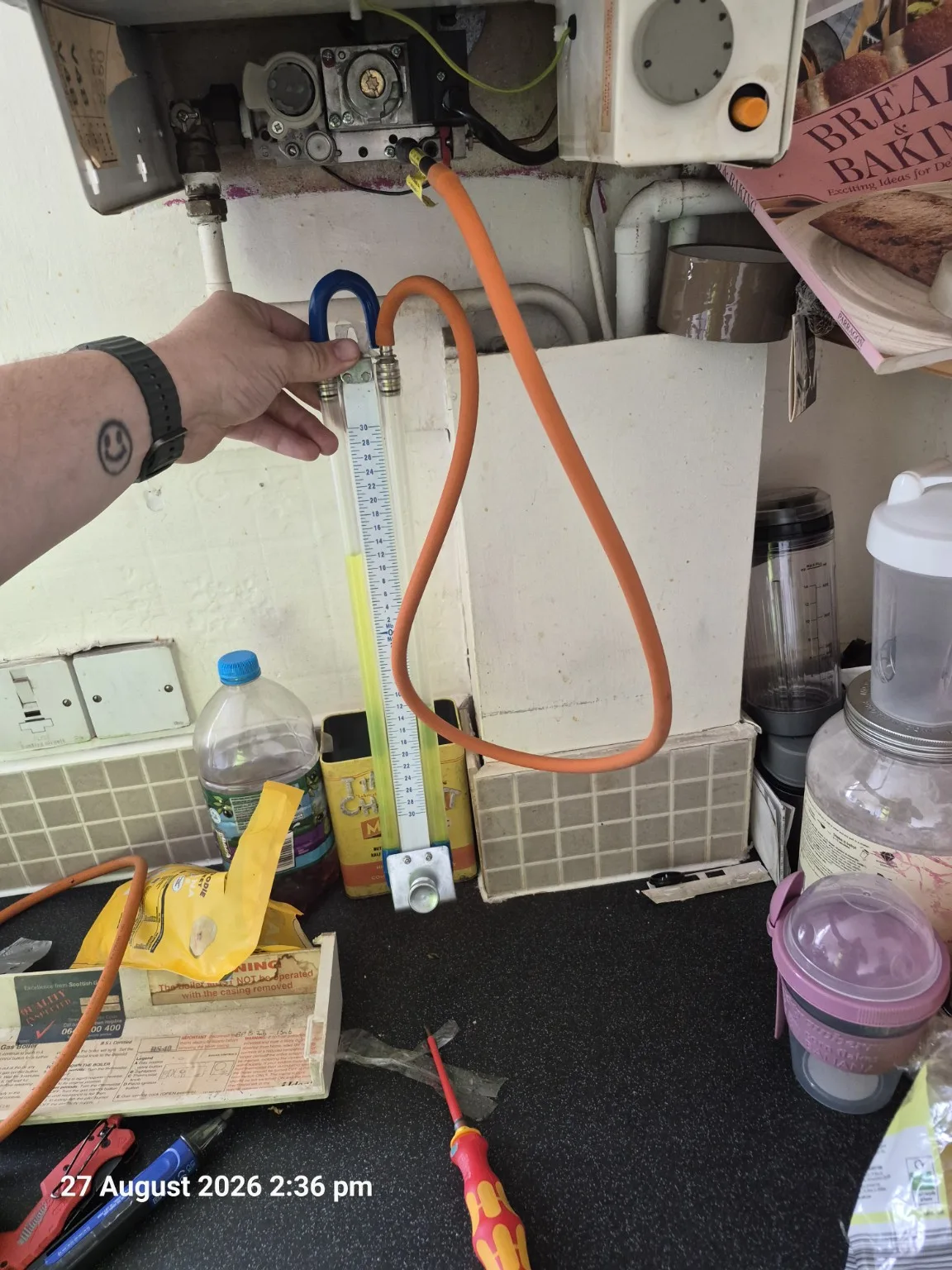 Gas pressure check being carried out during an Ideal RS230 boiler service