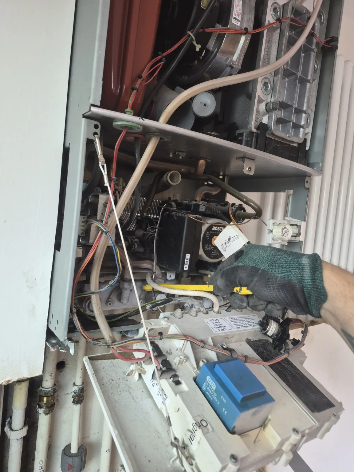 Close-up of internal boiler components during removal work