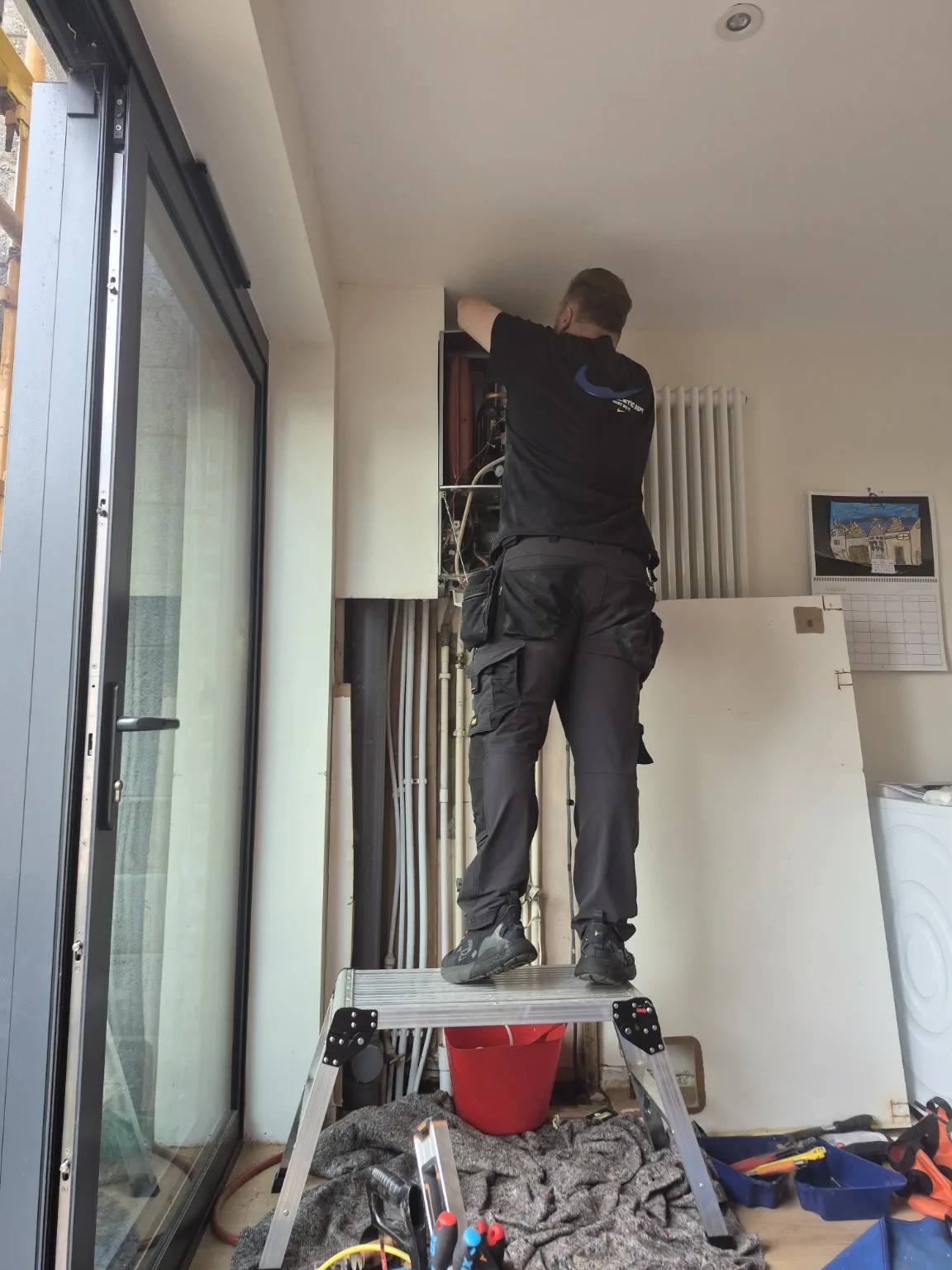 Engineer working on the older Worcester Bosch boiler before removal